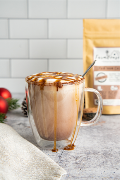 Bag of Hush’Room Cocoa Mix with a steaming mug of mushroom hot chocolate