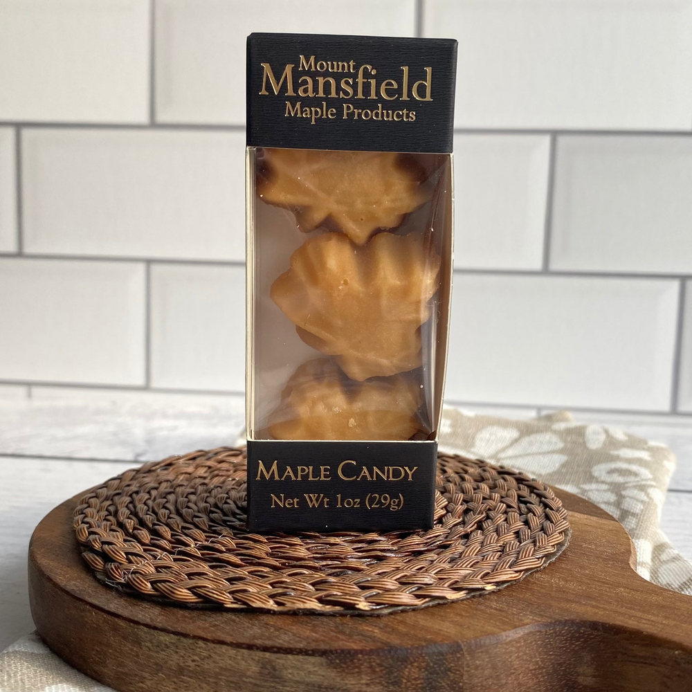 Box of Mansfield Maple Products maple candy on a wooden board with a tiled wall background