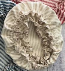 Collection of striped fabric headbands on a wooden surface