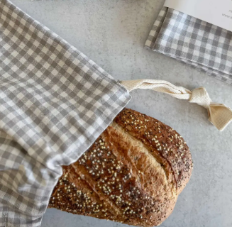 Checkered bread bags with 'dot&army' branding on a gray surface.