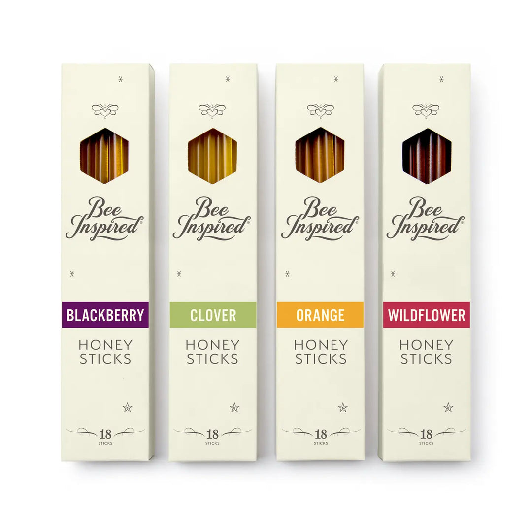 Four boxes of 'Bee Inspired' honey sticks with different flavors on a white background